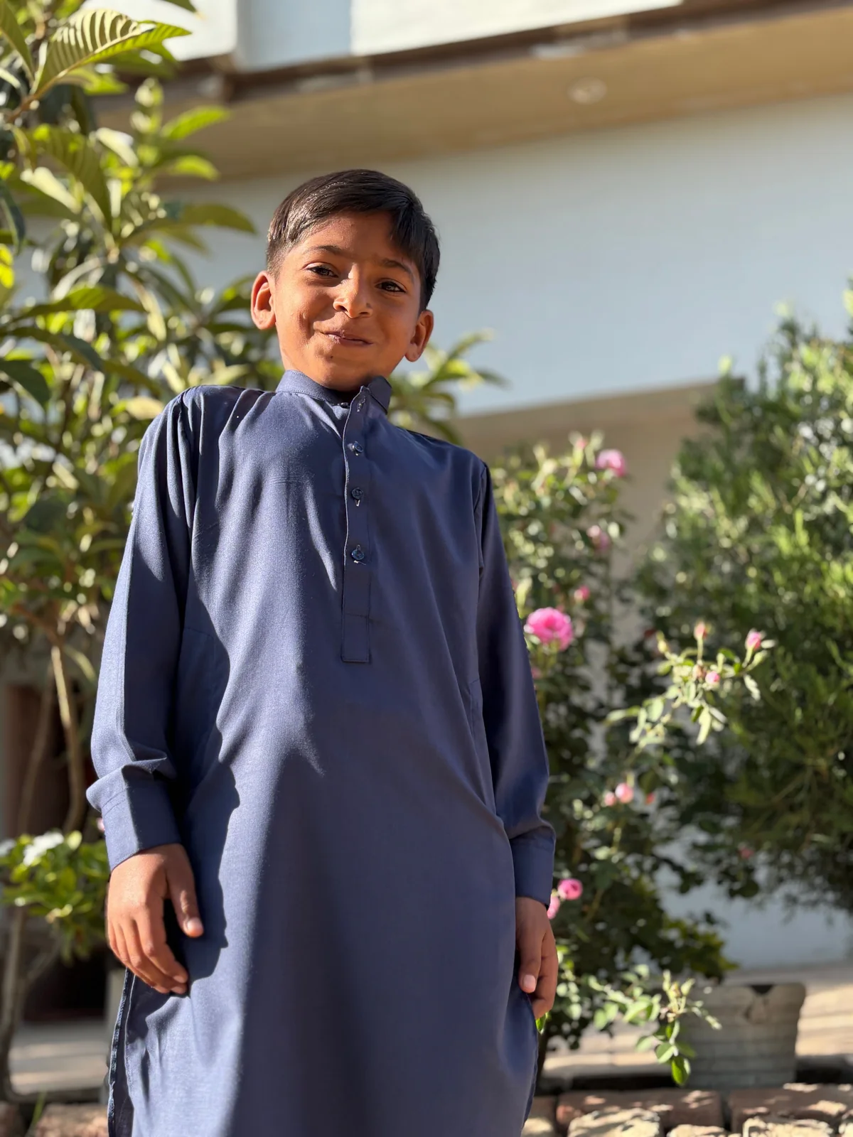 Young boy wearing a blue Pakistani kurta