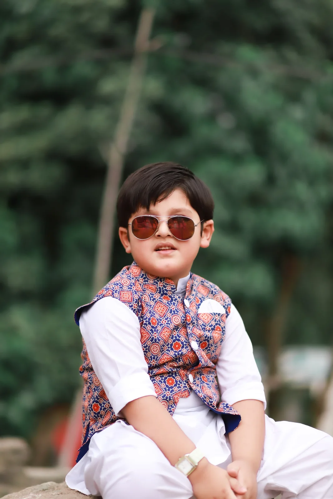 Young boy wearing a traditional waistcoat and kurta pajama