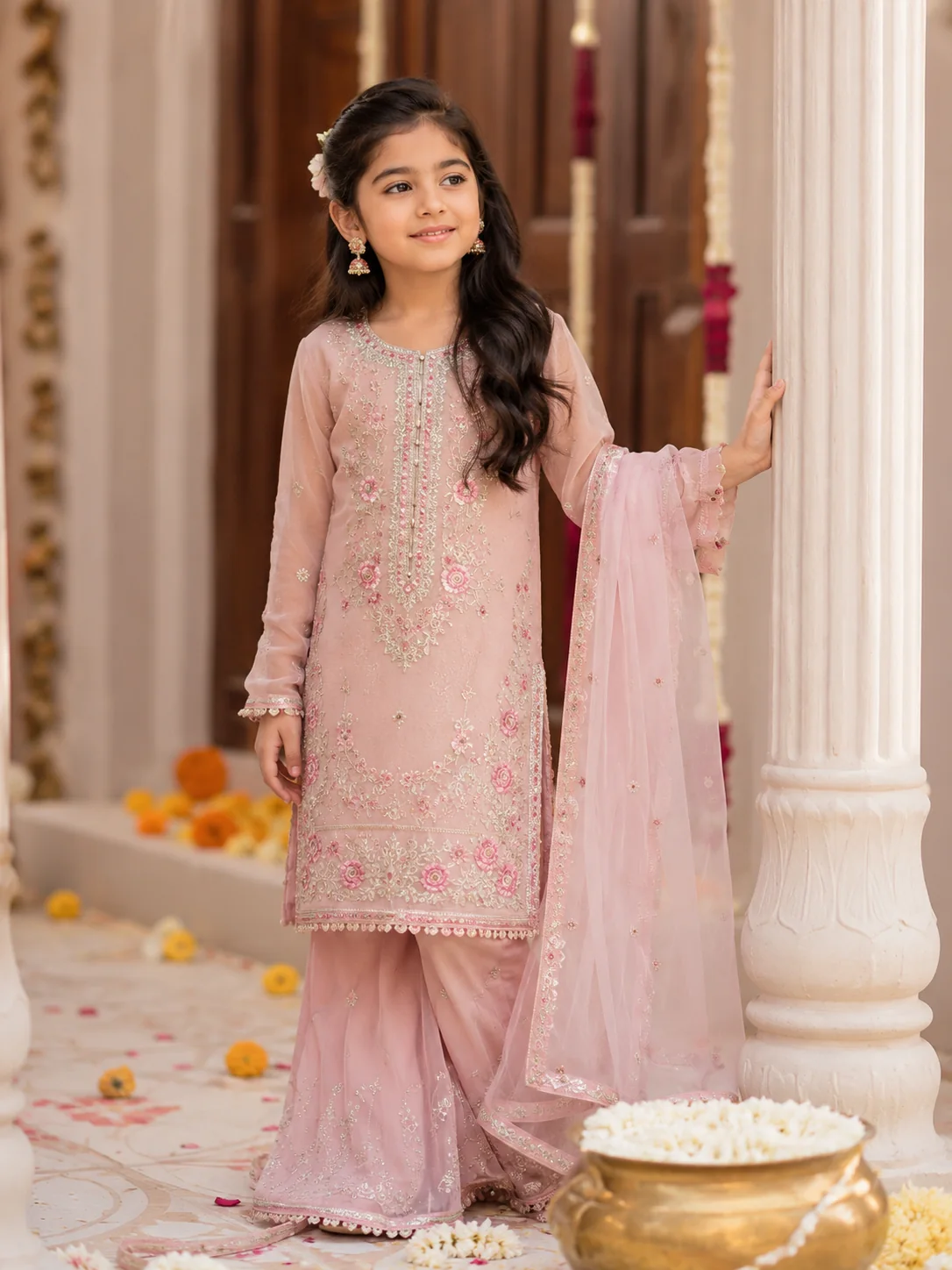 Young girl modeling a pink Pakistani traditional outfit